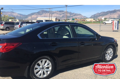 A well-detailed black car showcased in front of the Ogden mountains after an exterior detail.